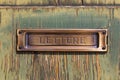 Brushed copper letter box on old painted wood Royalty Free Stock Photo