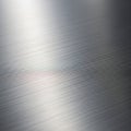 Close-up of a brushed metal surface with fine parallel lines creating a textured pattern. The Royalty Free Stock Photo