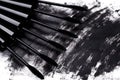 Close up of black brushes and smudged mascara