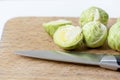 Close up of brussels cabbage sprouts green vegetables very famous in Brussels, isolated on wooden background with a knife
