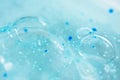 Close-up bubble blue shower gel with scrub grain texture with selective focus. Concept laboratory tests and research