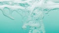 Close-up of Bubbles and Foam Forming in Turquoise Water with a Gentle Current and Soft Light Reflections Royalty Free Stock Photo