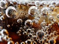 A close up of bubbles in a glass of soda