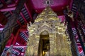 Close-up of Buddha image in golden pagoda at the main hall of Wat Prathat Lampang Luang, an ancient Buddhist temple in Lampang.