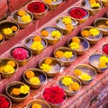 Close-up on Buddhist flower offerings in bowls.