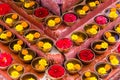 Close-up on Buddhist flower offerings in bowls.