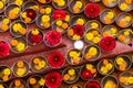 Close-up on Buddhist flower offerings in bowls.