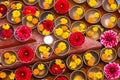 Close-up on Buddhist flower offerings in bowls.