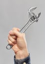 Close up of builder`s hand holding wrench Royalty Free Stock Photo