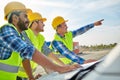 Close up of builders with blueprint on car hood Royalty Free Stock Photo