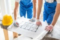 Close up of builders discussing blueprint Royalty Free Stock Photo