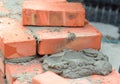 A close-up on building a brick wall, the process of bricklaying using mortar, cement and mason line