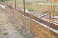 Close up on Building concrete slab foundation for new fence. Royalty Free Stock Photo