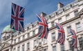 Close up of building on Regent Street London with row of British flags to celebrate the wedding of Prince Harry to Meghan Markle