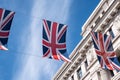 Close up of building on Regent Street London with row of British flags to celebrate the wedding of Prince Harry to Meghan Markle Royalty Free Stock Photo