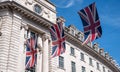 Close up of building on Regent Street London with row of British flags to celebrate the wedding of Prince Harry to Meghan Markle Royalty Free Stock Photo