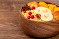 Close-up, bulgur porridge with slices of peach, banana and currant on a wooden background Royalty Free Stock Photo