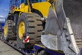 Close-up bulldozer on a transport platform. Concept: road construction, heavy construction equipment Royalty Free Stock Photo