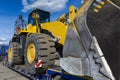 Close-up bulldozer on a transport platform. Concept: road construction, heavy construction equipment