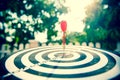 Close-up the bullseye target or dart board has red dart arrow throw hitting the center of a shooting