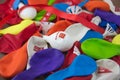 Close-up of a bunch of balloons with the different colors of the Spanish political parties