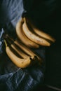 Close-up of a bunch of bananas on a dark fabric Royalty Free Stock Photo