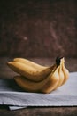 Close-up of a bunch of bananas on a dark fabric Royalty Free Stock Photo