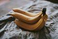 Close-up of a bunch of bananas on a dark fabric Royalty Free Stock Photo