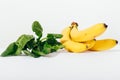 Close-up bunch of bananas and spinach leaves Royalty Free Stock Photo