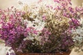 Close up a bunch of dried statice flowers in a wooden basket. Romantic flowers concept