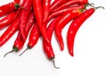 Close up of bunch of long red chili peppers on a white background isolated. It lies diagonally