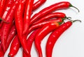 Close up of bunch of long red chili peppers on a white background isolated. It lies diagonally