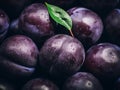 a close up of a bunch of plums with a leaf Royalty Free Stock Photo