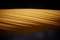 Close-up of raw spaghetti on a black background