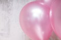 Close up of bunch of silver and pink baloons on gray concrete background