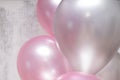 Close up of bunch of silver and pink baloons on gray concrete background Royalty Free Stock Photo