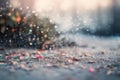 a close up of a bunch of small objects on the ground with water droplets on it and a blurry background of a tree in the