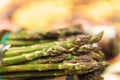 Close-up of bunches of green ripe asparagus on counter at market or grocery store in vegetable section Royalty Free Stock Photo