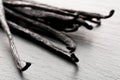 Close up of a bundle of dried bourbon vanilla beans or pods on black stone board Royalty Free Stock Photo