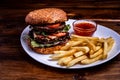 Close-up burger with beef cutlet and egg on a wooden board, close-up dark background Royalty Free Stock Photo