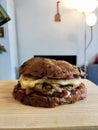 close-up burger with beef cutlet and egg on a wooden board close-up on the woode