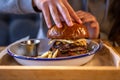 Close-up burger with egg and meat in a plate with sauce Royalty Free Stock Photo