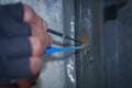 Close up of a burglar holding Lock-picker to open a housedoor Royalty Free Stock Photo