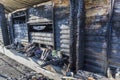 Close up Burned damaged ruins of destroyed supermarket metallic facade arson investigation insurance