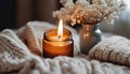 Close up of Burning candle in small amber glass jar on wooden plate - Cozy lifestyle concept