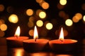 Close-up of burning candles on dark background. Soft, warm, and calming flame light. Multiple candles create peaceful atmosphere, Royalty Free Stock Photo