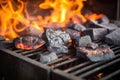 close-up of burning embers on a charcoal grill