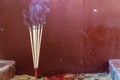 Close-up of burning incense sticks with smoke in the Buddhist temple Royalty Free Stock Photo