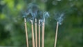 Close up of burning incense sticks with smoke