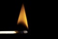 Close-up of a burning matchstick against a black background Royalty Free Stock Photo